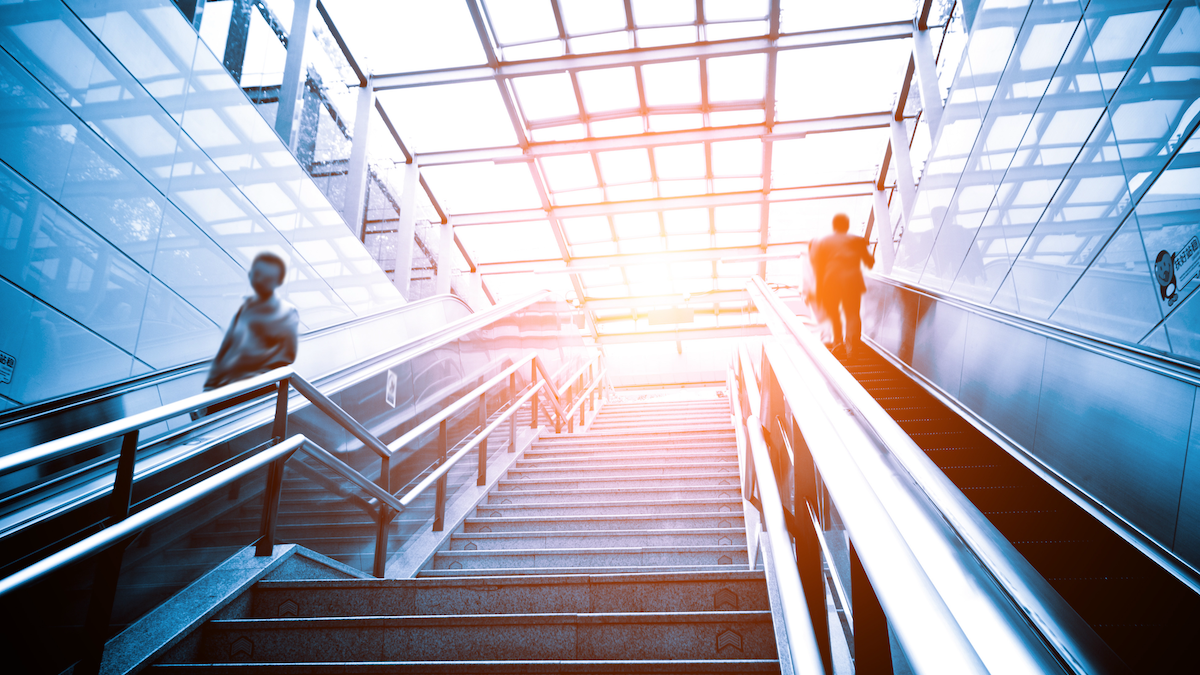 Stairs from below with sun shining at the top